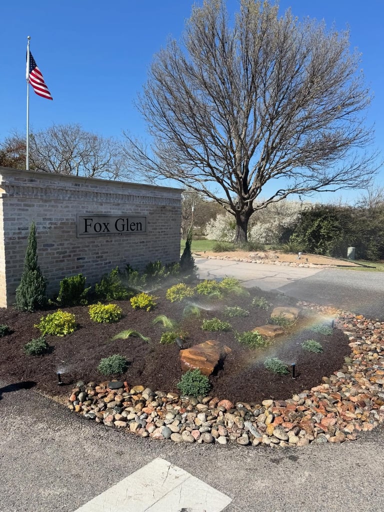 Pop-up sprinkler head watering a freshly installed irrigation zone in a green lawn