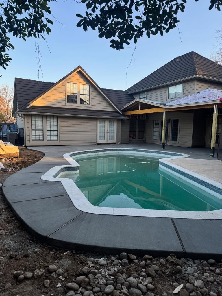 French drain and erosion-control trench installed beside a home foundation to redirect storm water
